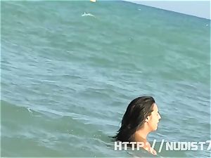 cool nudist chicks are took hold of on camera on a beach